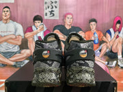 Rear view of Nike Air Max sneakers showing camouflage-style panels, heel branding, and circular sole elements.