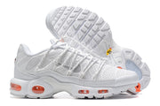 Side view of white Nike Air Max Plus sneakers with orange Air units and tread detail.