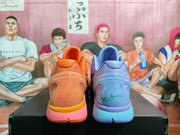 Rear view of the orange and ice-blue sneakers showing heel details, translucent sections, and colored midsoles.