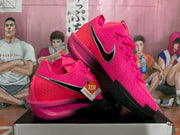 Angled side view of bright pink Nike basketball shoes with black and silver Swoosh detailing and a product tag.