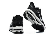 Black Nike Pegasus shoes shown from the heel and outsole, with white midsole sections.