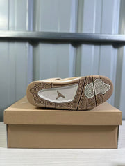 Bottom view showing the tan-and-light patterned rubber outsole and Jordan logo.