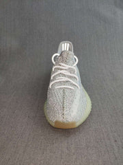Front view showing the white laces and silver knit-style upper.