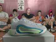 Side view of white Jordan sneakers with blue and green layered accents on a shoe box