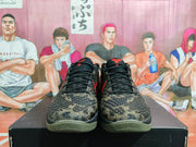 Front view of the pair showing the camouflage toe boxes, black laces, and red tongue details.