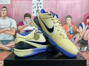 Pair of pale yellow and blue Nike basketball shoes shown from the side.