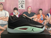 Side view of a black Jordan basketball sneaker with mint green cushioning accents and a visible Jumpman logo.