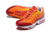 Pair of orange and red Nike Air Max 95 TT sneakers from an angled front view