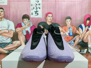 Front view of the purple shoes with black laces and bright green accents