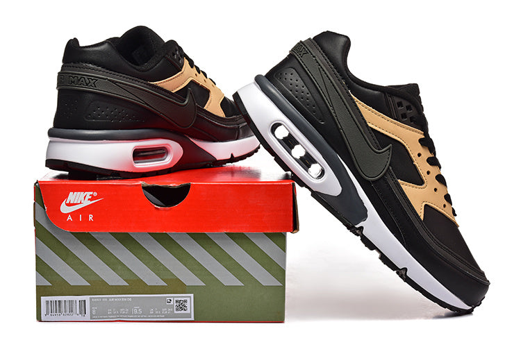 Black and tan Nike Air Max sneakers displayed on a branded shoe box.