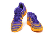 Pair of purple and gold Nike Ja basketball shoes shown from the front