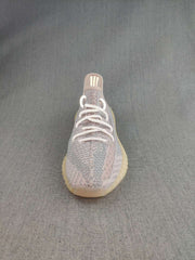 Front view of a Yeezy 350 V2 style sneaker showing the rounded toe, knit upper, and white laces.