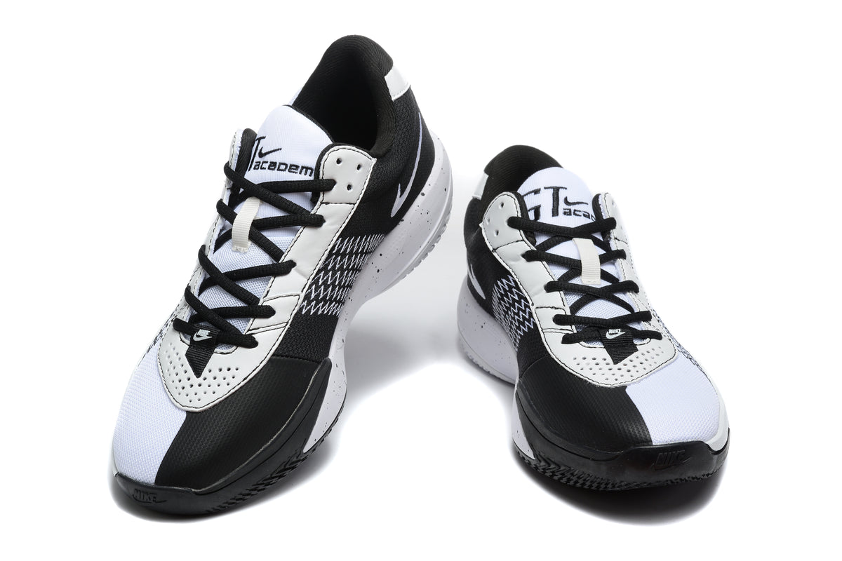 Pair of white and black Nike Academy basketball sneakers shown from a front three-quarter angle.