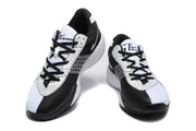 Pair of white and black Nike Academy basketball sneakers shown from a front three-quarter angle.