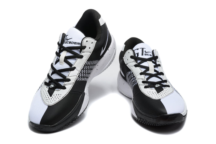 Pair of white and black Nike Academy basketball sneakers shown from a front three-quarter angle.