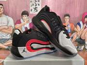 Angled view of the pair highlighting the black upper, white and red side detailing, and translucent outsole.