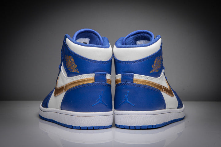 Rear view of blue and white high-top Jordan sneakers with gold wing branding and blue outsoles.