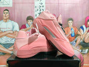 Angled view of pink Jordan basketball shoes showing the side, heel, and outsole