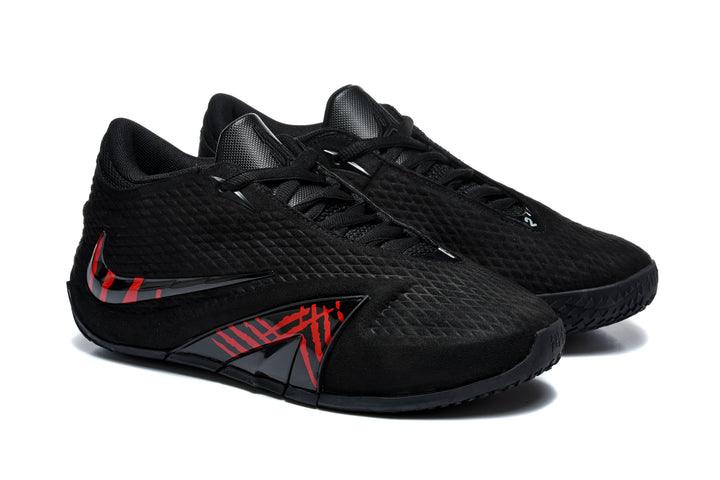 Pair of black low-top basketball shoes with red and dark gray side graphics