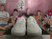Front view of a pair of white Nike basketball shoes with lace-up closures.
