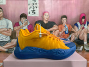 Side view of yellow and blue basketball sneakers with orange-toned laces and a sculpted blue sole