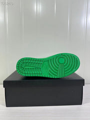 Underside view of the green sneaker showing a circular and segmented traction pattern.