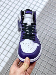 Front view showing the perforated white toe box, purple overlays, and black laces.