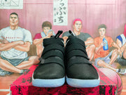 Front view showing the black textured-look uppers and strap closures of the pair.