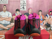 Rear view of Nike high-top basketball sneakers showing pink collars, black heel panels, red and dark camouflage-style detailing, and “THE GLOVE” text.