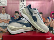 Pair of white and navy PUMA Rider Elite sneakers with a sculpted sole