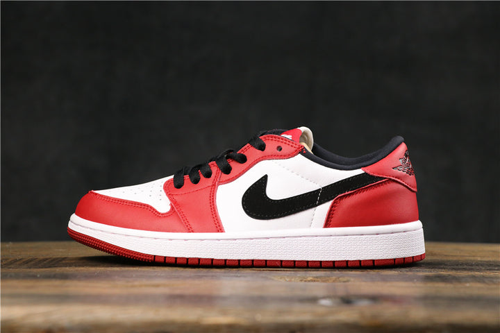 Side view of red, white, and black low-top Jordan-style sneakers with black laces, a black Swoosh, white midsole, and red outsole.