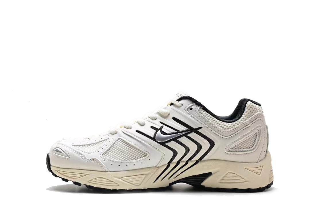 White and black Nike low-top sneakers with mesh panels and a sculpted contrasting sole