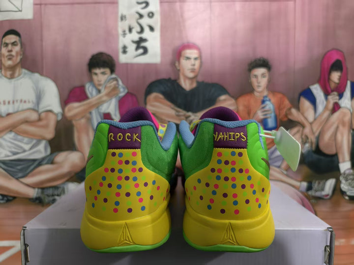Rear view of multicolor Nike basketball shoes with green and yellow heels, dotted details, and purple heel tabs