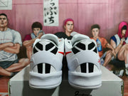 Rear view of the sneakers showing white heel sections with black graphic panels and red accents.