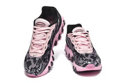 Front and top views of black and pink Nike Air Max DN8 sneakers with pink laces.