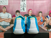 Rear view of the pair showing blue heel panels, white heel sections, lime details, and Jumpman logos.