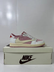 Side profile of one sneaker showing the layered white and pink upper with cream Swoosh branding.