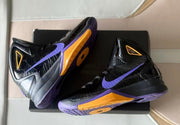 Pair of high-top basketball shoes showing purple-and-gold outsole details