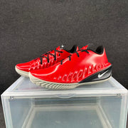 Pair of red and black Nike GT basketball shoes with black laces