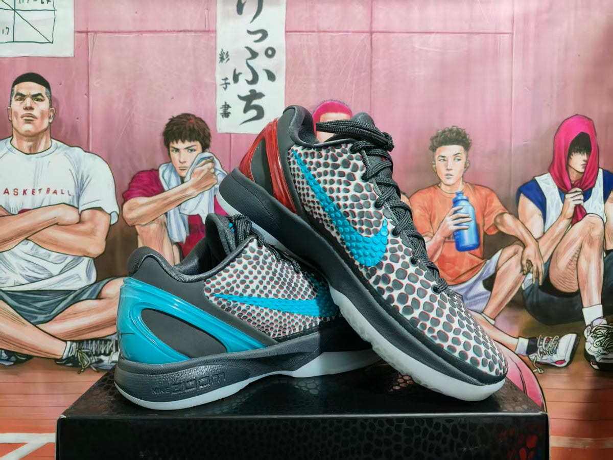 Pair of black, gray, blue, and red Nike basketball sneakers displayed on a box
