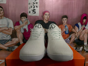 Front view showing the white laces, textured uppers, and branded tongues.