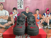 Front view of red and black Nike sneakers showing the lace-up closure, padded tongues, and contrasting Swoosh details.