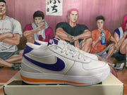 Side profile of a white Nike low-top sneaker with a blue-purple Swoosh and orange outsole accent.
