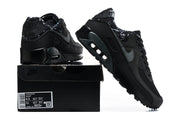 Black Nike Air Max 90 sneakers shown with a black shoe box; the box label shows a US Men’s 9.5 sample size.