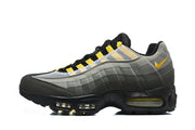 Side view of a Nike Air Max 95 TT sneaker in grey, charcoal and yellow.