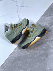 Pair of green high-top sneakers displayed from an angled side view.