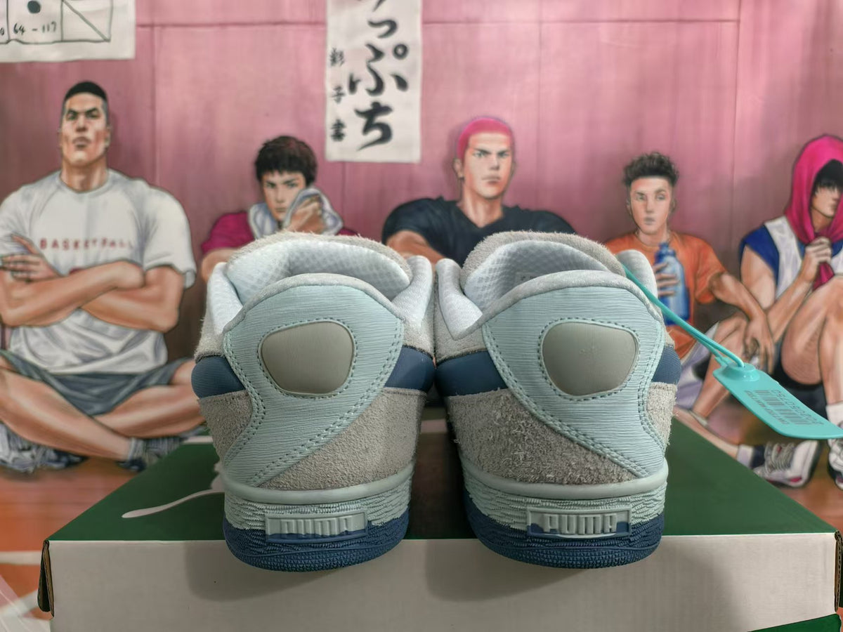 Rear view of gray and blue low-top Puma sneakers