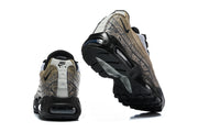 Rear and outsole views of patterned Nike Air Max 95 TT sneakers.