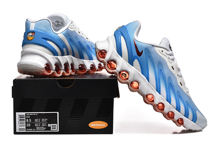Blue and white Nike Air Max DN sneakers displayed on a black shoebox; the box label shows a sample size.