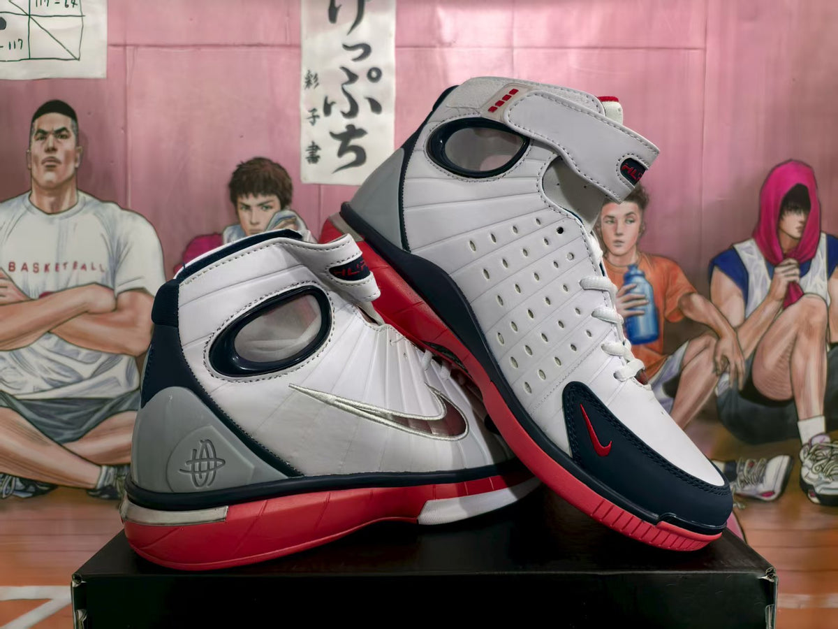 Pair of white, navy blue, red, and gray Nike high-top sneakers shown from an angled side view.